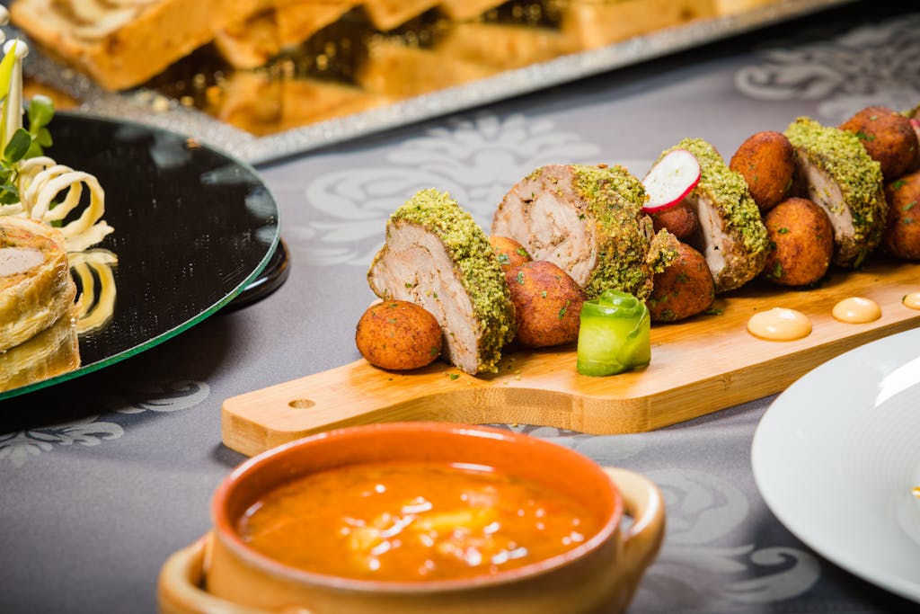 Close-up of a beautifully plated meat dish with various sides, perfect for a refined dining experience.