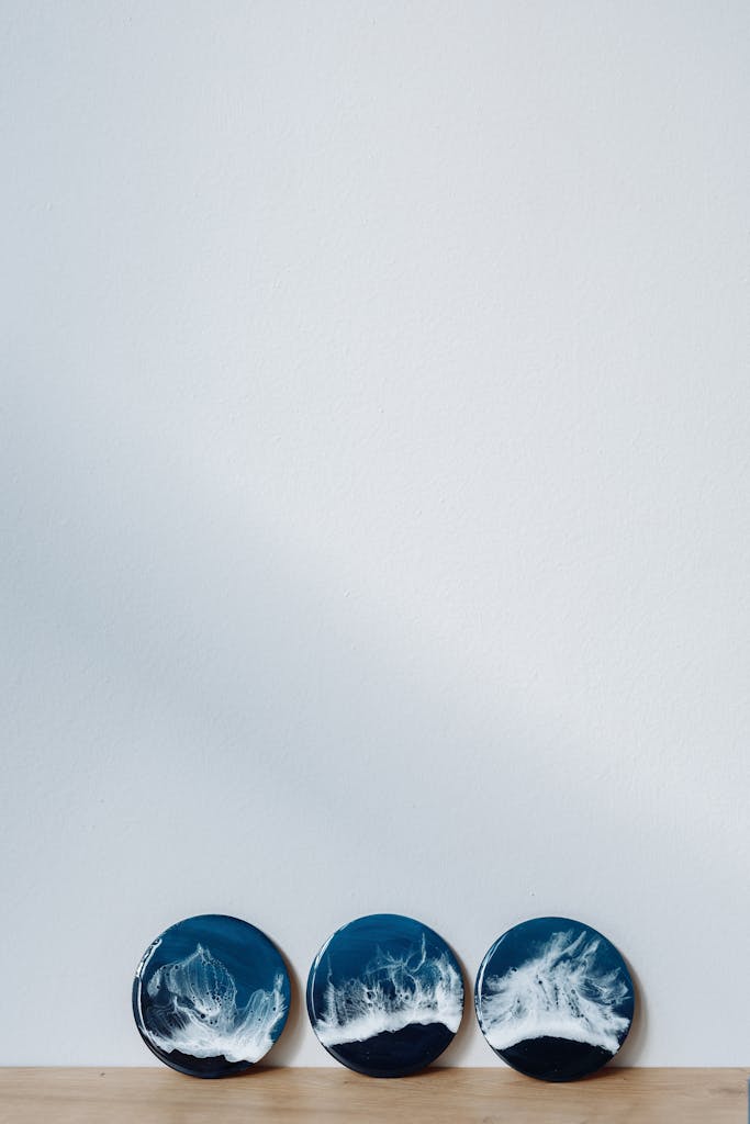 Three artistic ocean-themed ceramic plates displayed against a white background with ample copy space.